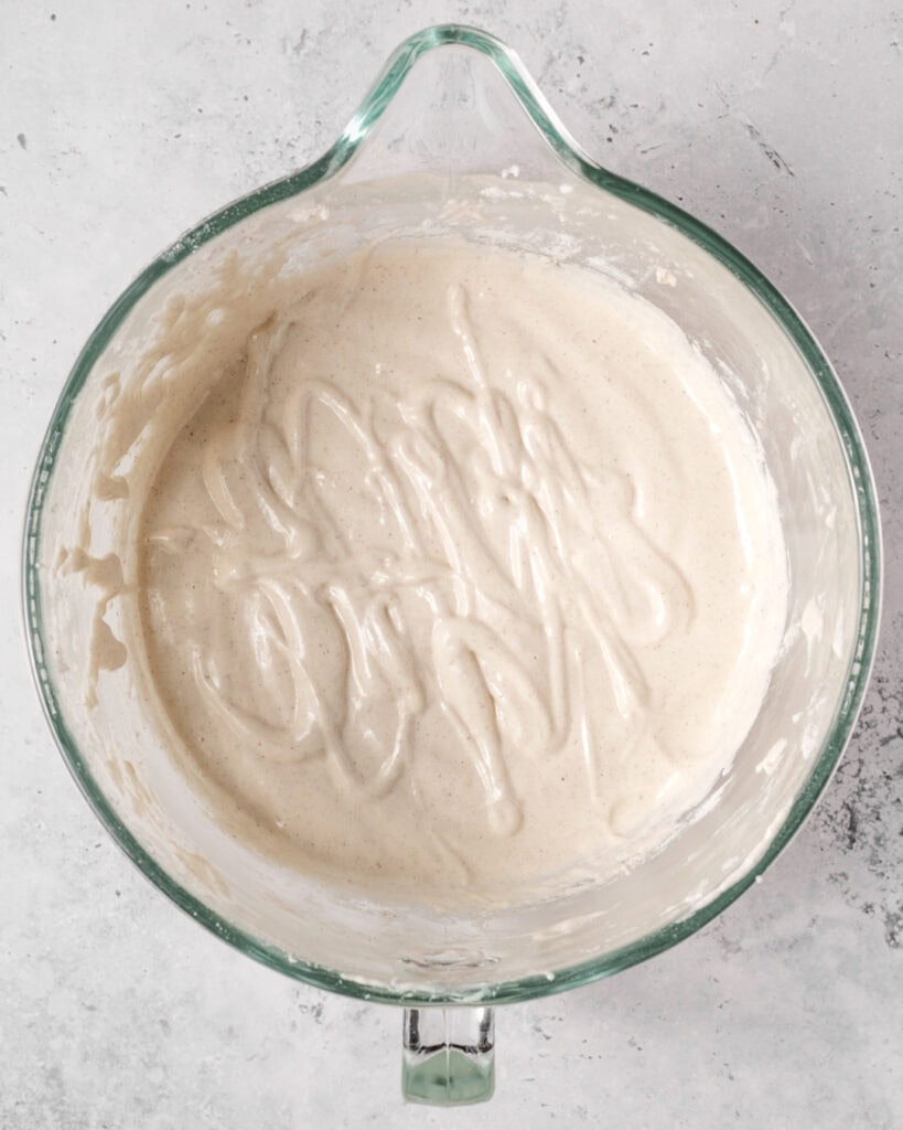 Light and fluffy sponge cake batter with a smooth texture in a glass mixing bowl.