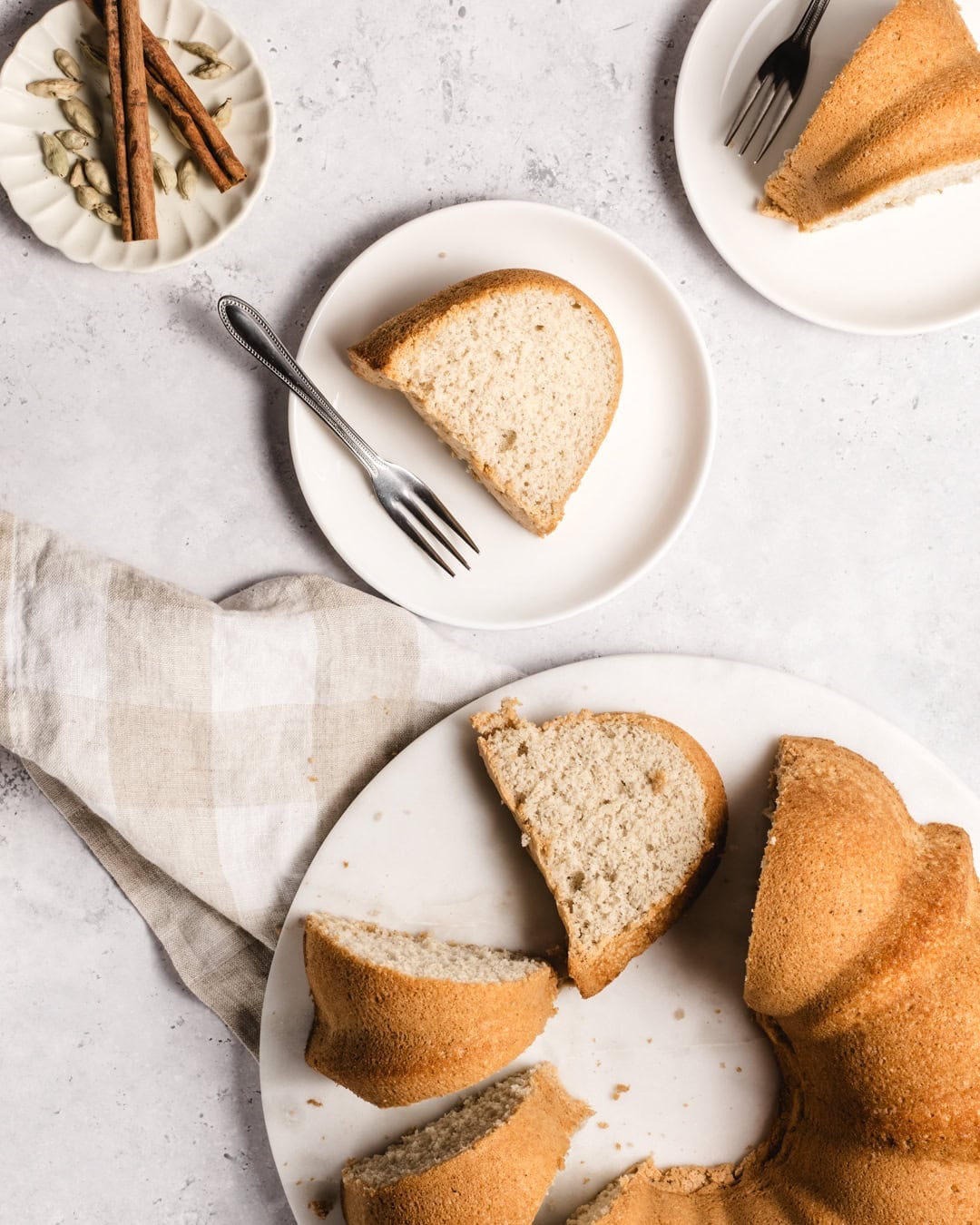 Delicious slice of Somali sponge cake on a white plate with a fork, showing its soft, fluffy texture.