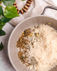 Cooked Somali Bariis rice with spiced meat in a frying pan, ready to serve.
