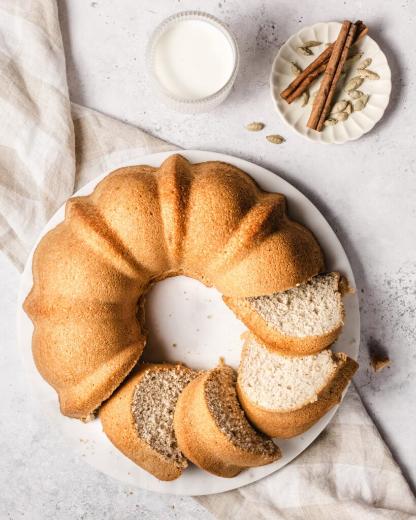 Slice of vanilla bundt cake with cinnamon and nutmeg on top.